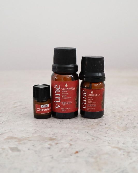 Frascos de aceite esencial de citronela Vuné de 2ml, 5ml y 10ml sobre fondo de piedra